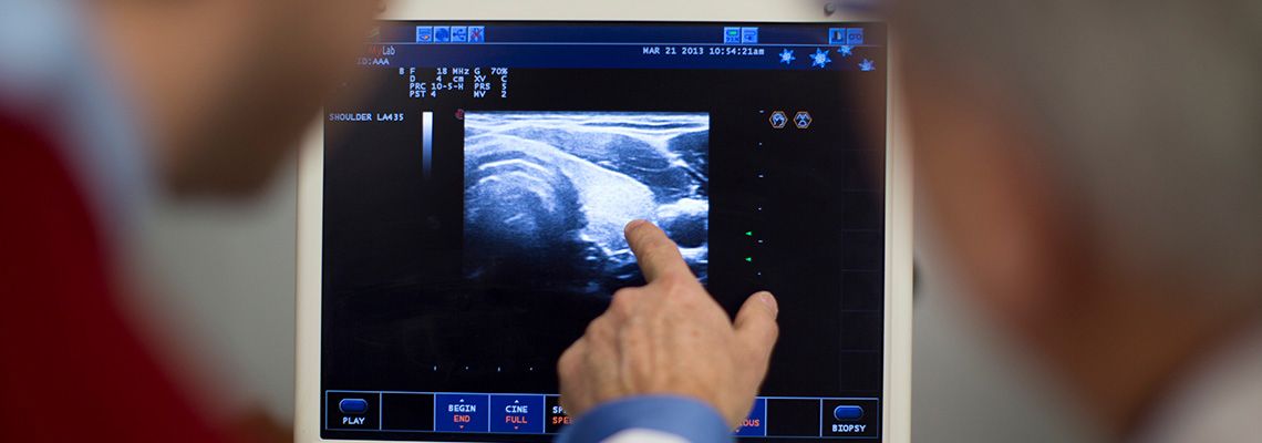 Doctor pointing to image on a monitor