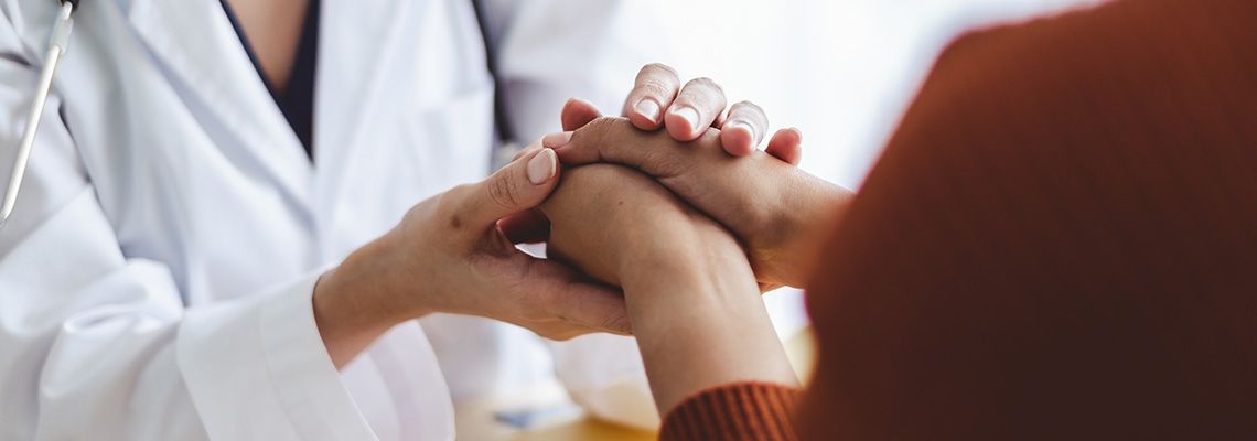 provider holding patients hands