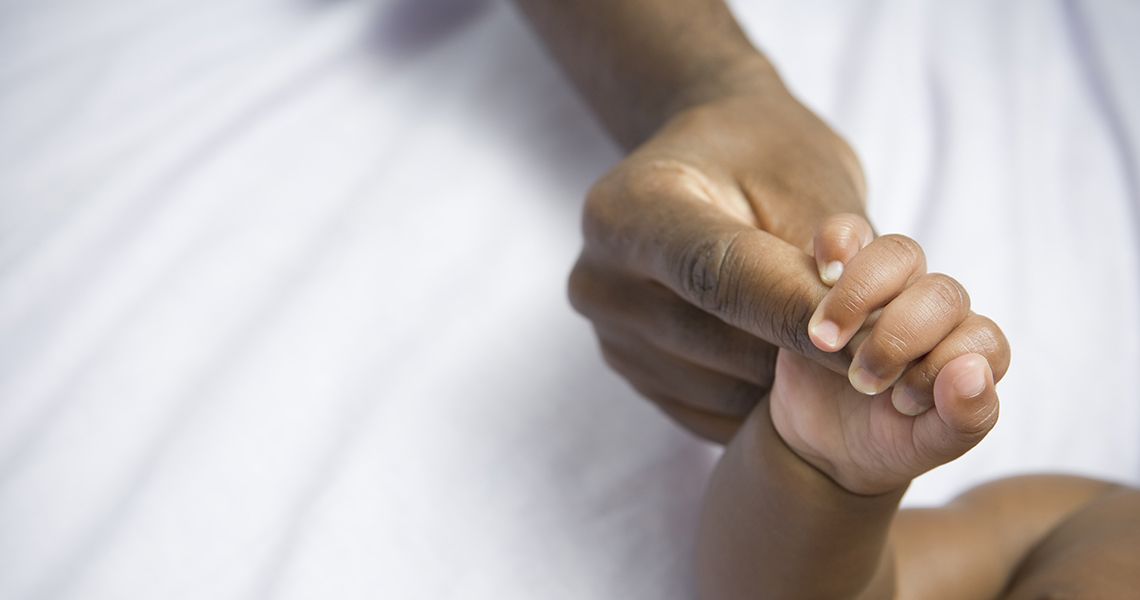 Close Up of mom holding baby's hand