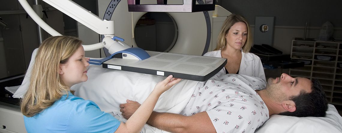 doctors setting up patient with radiation therapy
