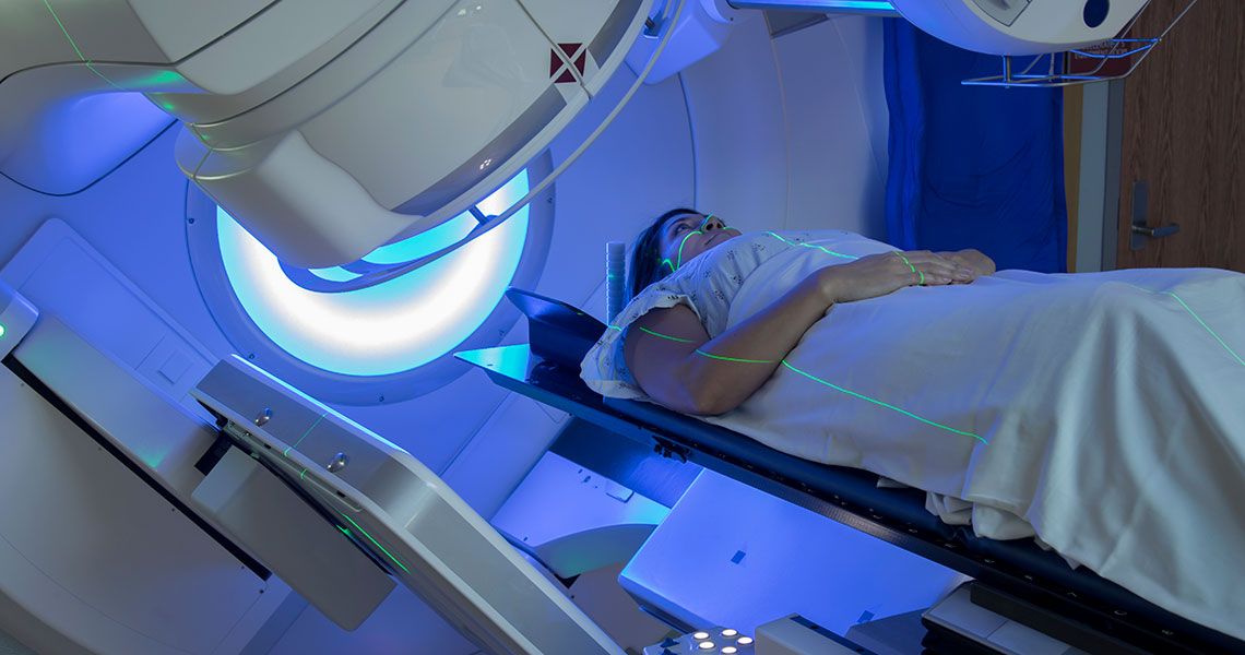 A patient lying in a radiation therapy machine