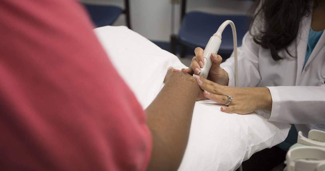 rheumatologist scanning someone's hand