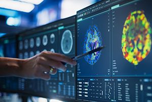 Someone pointing to a brain MRI