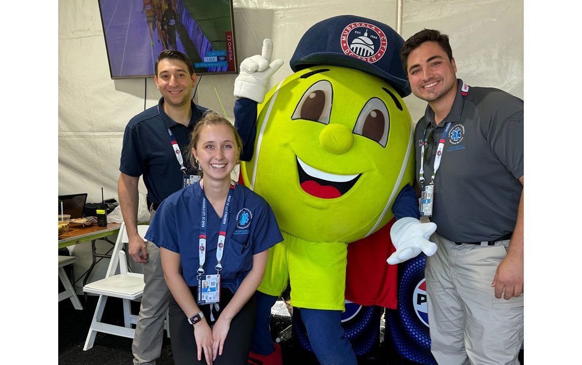 GW Operational Medicine team in a medical tent with a tennis ball mascot