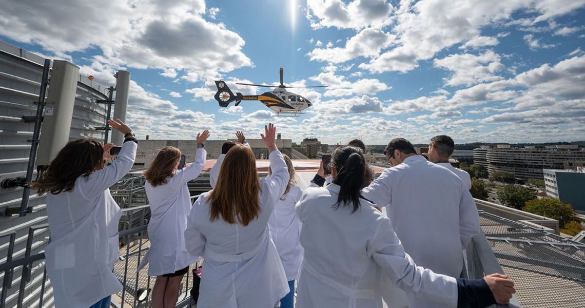Doctors waving at a helicopter