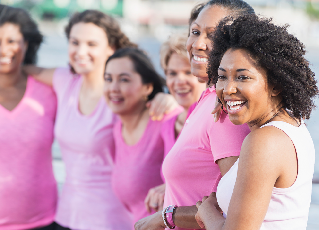 Women smiling and wearing pink