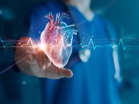 blurred doctor in the background pointing to a hologram-like image of a heart